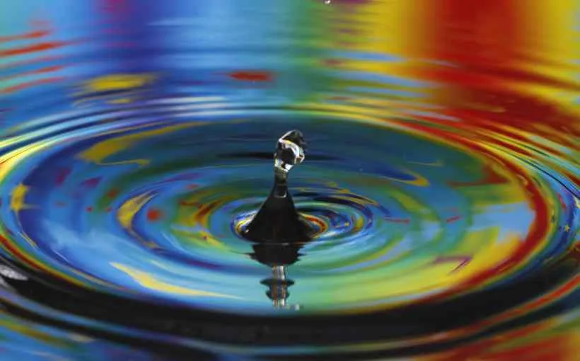 Water droplet rising from a rainbow-coloured ripple, illustrating the ripple effect of direct customer engagement