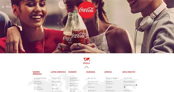 Coca-Cola website showing friends clinking bottles above a global menu of countries sorted by region