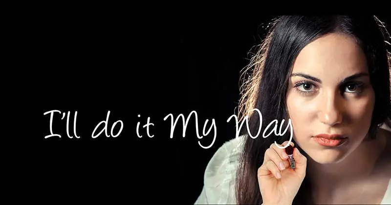 Woman with dark hair looking intently at the camera, writing "I'll do it My Way" in white script to show a go-it-alone networker
