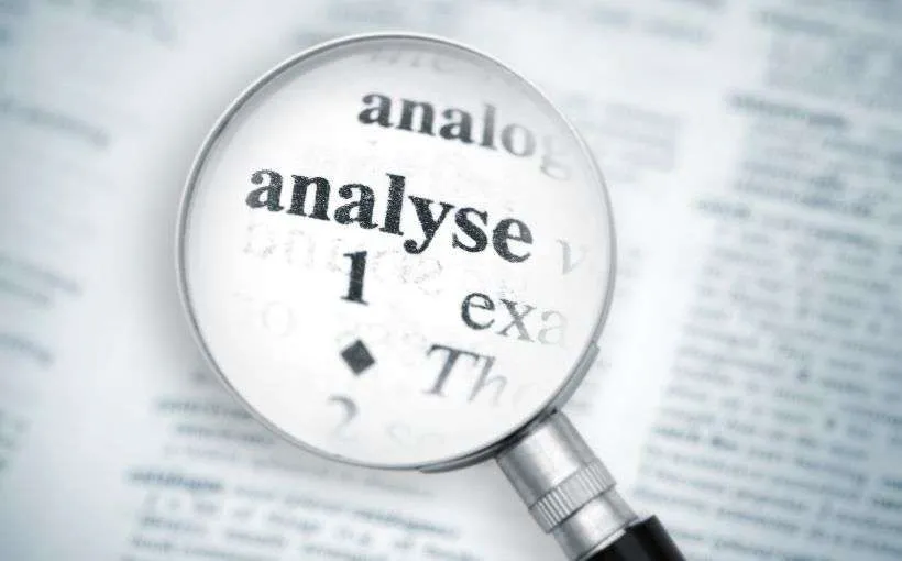 Magnifying glass over a dictionary entry for the word "analyse", representing a closer look at what makes content go viral