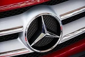 Mercedes-Benz three-pointed star on a red car grille, an example of an instantly recognisable brand