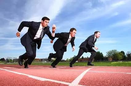 Three men in business suits crouch mid-start on a running track, illustrating the fast-moving "Go-Getters" group